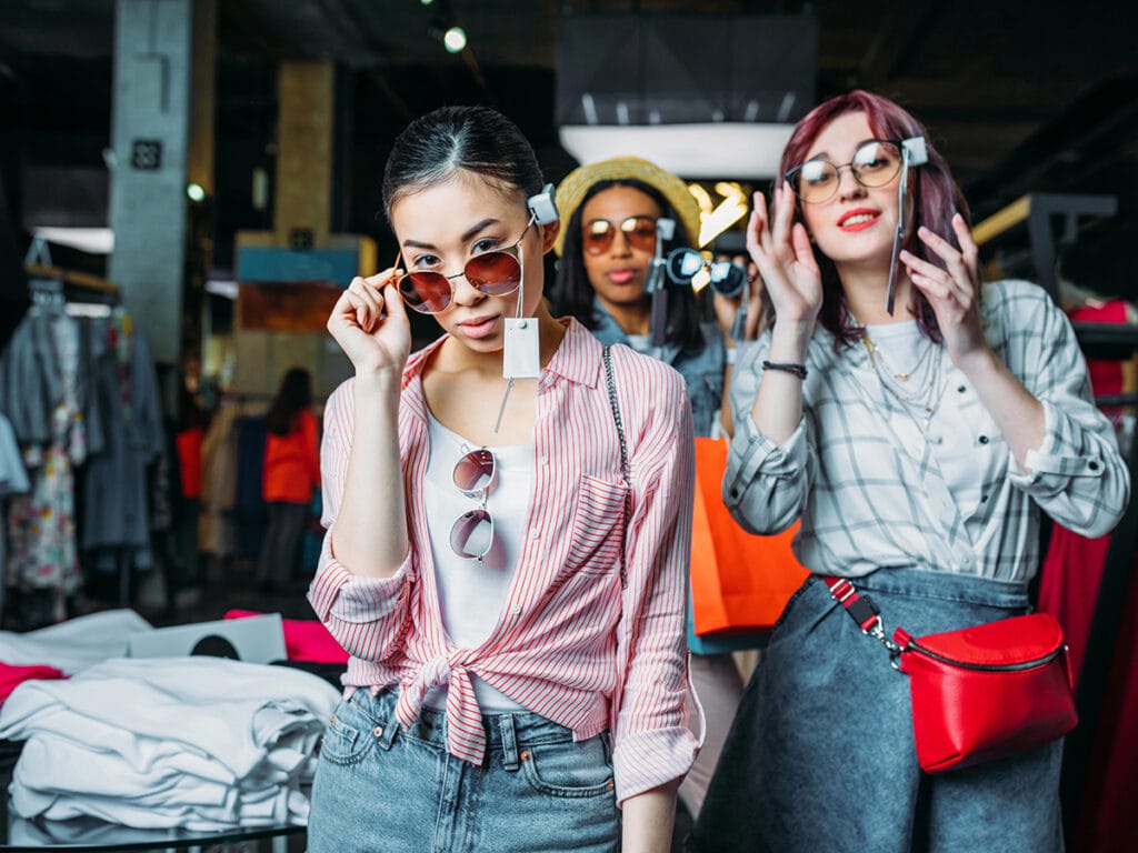 Women trying on sunglasses in a boutique
