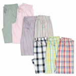 An assortment of unisex pajama pants in various solid colors and patterns.