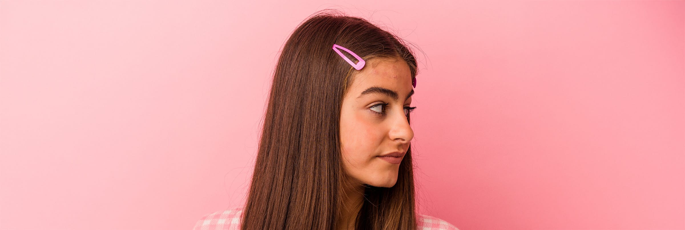 Young girl with pink barrette in her hair.