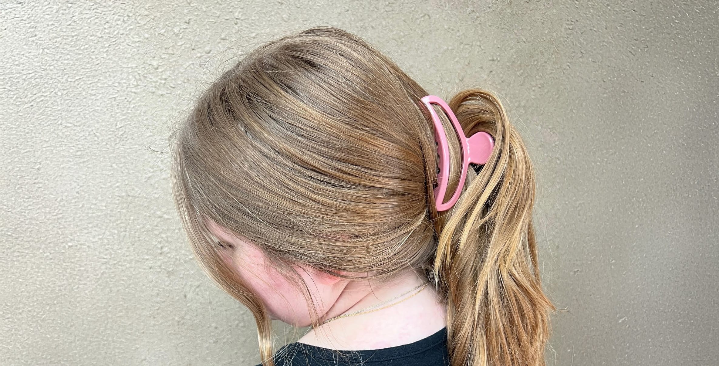 Girl with pink crescent shaped jaw clip in her hair.