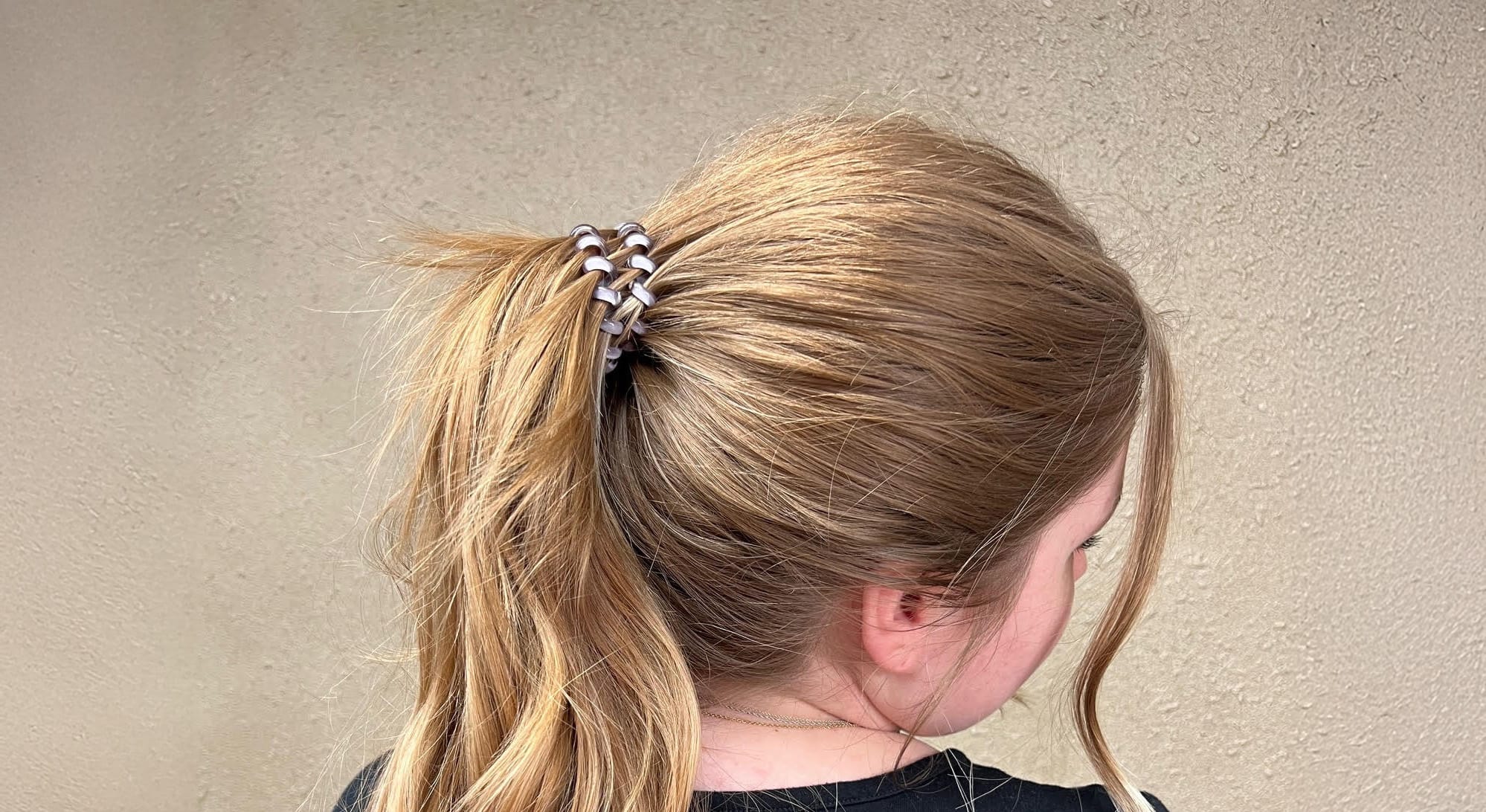 Girl with telecord pony o in her hair.
