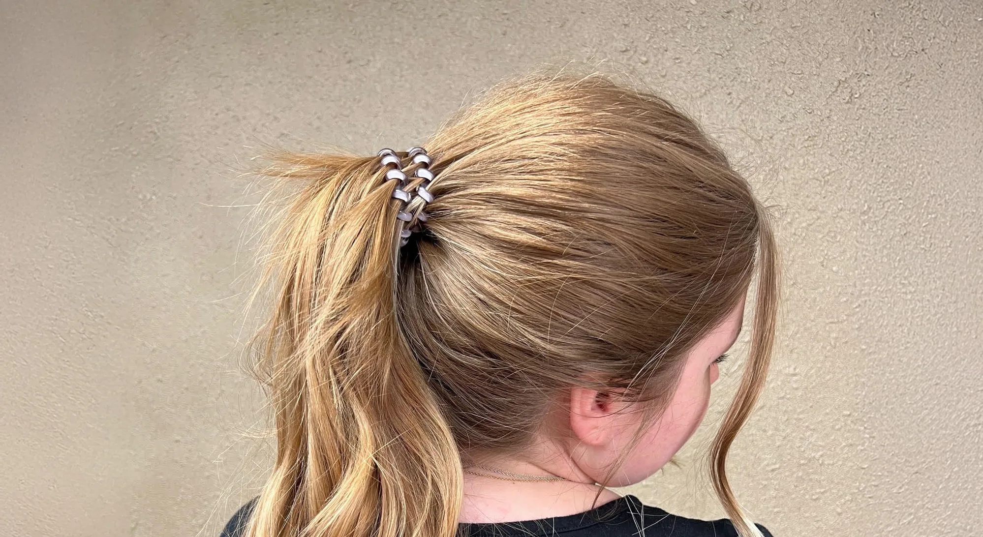 Girl with telecord pony o in her hair.