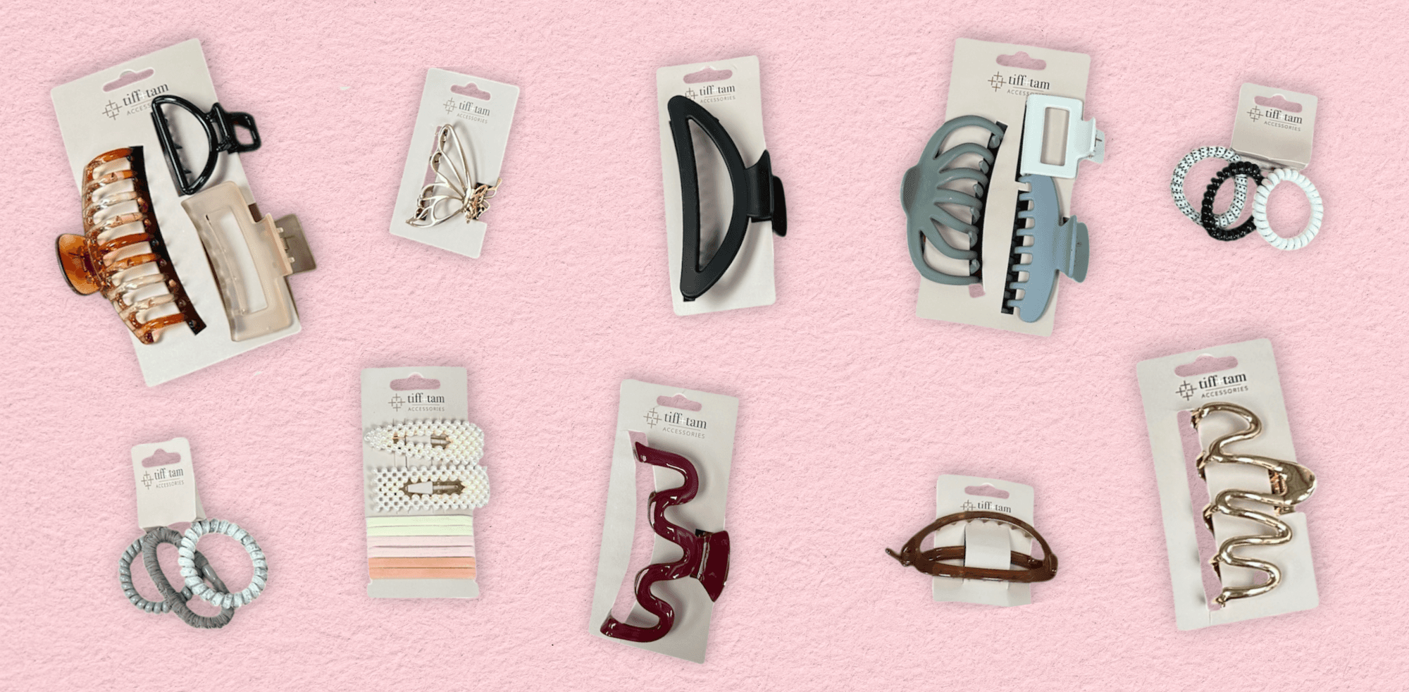 Assorted tiff + tam hair accessories including claw clips, spiral hair ties, snap clips, and statement barrettes on a pink background.